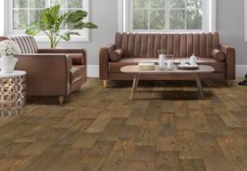 Vintage living room with mid-century modern brown leather sofas and aged wooden flooring